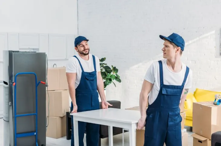 Movers carrying a table