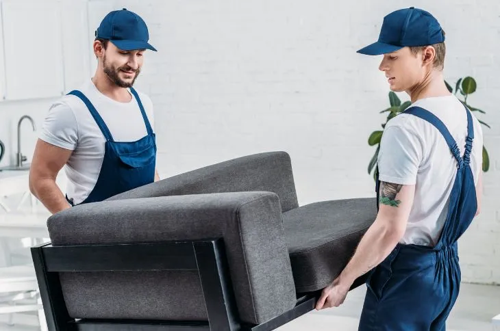 Group of movers unloading a moving truck.